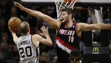 Jan 17, 2014; San Antonio, TX, USA; San Antonio Spurs guard Manu Ginobili (20) drives to the basket as Portland Trail Blazers center Joel Freeland (19) defends during the first half at AT&T Center. Mandatory Credit: Soobum Im-USA TODAY Sports