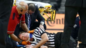 Nov 29, 2014; Brooklyn, NY, USA; NCAA referee Rick Crawford is tended to as he lays on the court shortly after tip-off during the first half between the Vanderbilt Commodores and the La Salle Explorers at Barclays Center. Mandatory Credit: Brad Penner-USA TODAY Sports