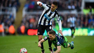 NEWCASTLE UPON TYNE, ENGLAND - APRIL 16: Newcastle player Aleksander Mitrovic races past Federico Fernandez of Swansea during the Barclays Premier League match between Newcastle United and Swansea City at St James' Park on April 16, 2016 in Newcastle Upon Tyne, England. (Photo by Stu Forster/Getty Images)
