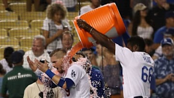 LOS ANGELES, CA - AUGUST 01: Yasmani Grandal #9 of the Los Angeles Dodgers is doused with Gatorade by teammate Yasiel Puig #66 after Grandal hit a two-run walk-off homerun over the right field fence in the tenth inning of the MLB game against the Milwaukee Brewers at Dodger Stadium on August 1, 2018 in Los Angeles, California. The Dodgers defeated the Brewers 6-4. (Photo by Victor Decolongon/Getty Images)