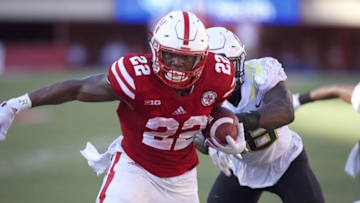 Sep 17, 2016; Lincoln, NE, USA; Nebraska Cornhuskers running back Devine Ozigbo (22) scores a touchdown against Oregon Ducks linebacker Jimmie Swain (18) in the second half at Memorial Stadium. Nebraska won 35-32. Mandatory Credit: Bruce Thorson-USA TODAY Sports