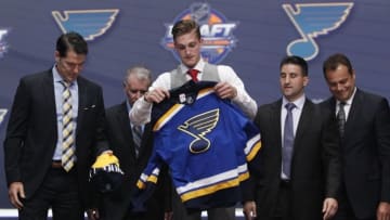Jun 24, 2016; Buffalo, NY, USA; Tage Thompson puts on a team jersey after being selected as the number twenty-six overall draft pick by the St. Louis Blues in the first round of the 2016 NHL Draft at the First Niagra Center. Mandatory Credit: Timothy T. Ludwig-USA TODAY Sports