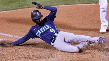 OAKLAND, CALIFORNIA - SEPTEMBER 25: Dee Strange-Gordon #9 of the Seattle Mariners scores on a passed ball against the Oakland Athletics in the top of the 10th inning at RingCentral Coliseum on September 25, 2020 in Oakland, California. (Photo by Thearon W. Henderson/Getty Images)