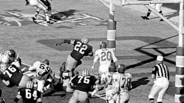 Green Bay's Elijah Pitts (22) charges into the end zone, eluding Bobby Hunt (20), during the first Super Bowl in Los Angeles, Jan. 16, 1967. Pitts scored from the five on the play following Willie Wood's interception in the third quarter. Packers beat the Chiefs, 35-10.Elijah Pitts Bobby Hunt