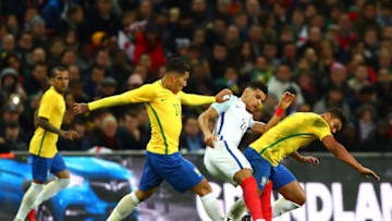 LONDON, ENGLAND - NOVEMBER 14: Firmino of Brazil and Casemiro of Brazil tackles Dominic Solanke of England during the international friendly match between England and Brazil at Wembley Stadium on November 14, 2017 in London, England. (Photo by Clive Rose/Getty Images)