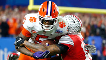 GLENDALE, ARIZONA - DECEMBER 28: Tee Higgins #5 of the Clemson Tigers is tackled by Amir Riep #10 of the Ohio State Buckeyes in the second half during the College Football Playoff Semifinal at the PlayStation Fiesta Bowl at State Farm Stadium on December 28, 2019 in Glendale, Arizona. (Photo by Ralph Freso/Getty Images)