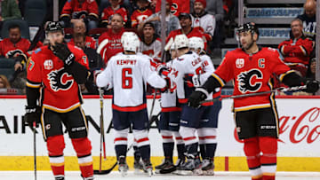 CALGARY, AB - OCTOBER 22: Chandler Stephenson #18, John Carlson #74 and Michal Kempny #6 of the Washington Capitals and teammates celebrate a goal against the Calgary Flames on October 22, 2019 at the Scotiabank Saddledome in Calgary, Alberta, Canada. (Photo by Gerry Thomas/NHLI via Getty Images)