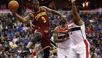 Feb 7, 2014; Washington, DC, USA; Cleveland Cavaliers guard Dion Waiters (3) leaps to pass the ball as Washington Wizards center Kevin Seraphin (13) defends in the fourth quarter at Verizon Center. The Cavaliers won 115-113. Mandatory Credit: Geoff Burke-USA TODAY Sports