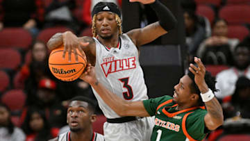 Dec 17, 2022; Louisville, Kentucky, USA; Louisville Cardinals guard El Ellis (3) battles Florida A&M Rattlers guard Byron Smith (1) for a rebound during the second half at KFC Yum! Center. Louisville defeated Florida A&M 61-55. Mandatory Credit: Jamie Rhodes-USA TODAY Sports