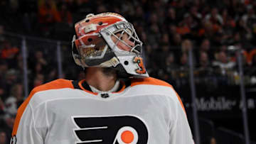 Michal Neuvirth #30 of the Philadelphia Flyers takes a break during a stop in play in the second period of a game against the Vegas Golden Knights. (Photo by Ethan Miller/Getty Images)