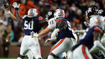 Auburn footballTexas A&M Aggies quarterback Conner Weigman (15) throws the ball around Auburn Tigers defensive lineman Marcus Harris (50) as Auburn Tigers take on Texas A&M Aggies at Jordan-Hare Stadium in Auburn, Ala., on Saturday, Nov. 12, 2022. Auburn Tigers lead Texas A&M 7-0 at halftime.