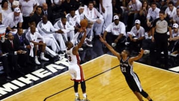 Jun 20, 2013; Miami, FL, USA; Miami Heat shooting guard Dwyane Wade (3) shoots against San Antonio Spurs power forward Tim Duncan (21) during the fourth quarter of game seven in the 2013 NBA Finals at American Airlines Arena. Miami defeated San Antonio 95-88 to win the NBA Championship. Mandatory Credit: Robert Mayer-USA TODAY Sports