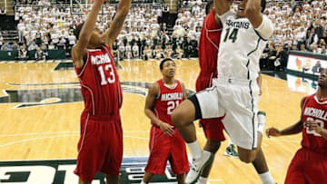December 1, 2012; East Lansing, MI, USA; Michigan State Spartans guard Gary Harris (14) drives to the basket against Nicholls State Colonels forward Travis Julien (13) during the second half at Jack Breslin Students Events Center. MSU won 84-39. Mandatory Credit: Mike Carter-USA TODAY Sports