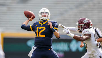 Sep 12, 2020; Morgantown, West Virginia, USA; West Virginia Mountaineers quarterback Austin Kendall (12) throws a pass during the third quarter against the Eastern Kentucky Colonels at Mountaineer Field at Milan Puskar Stadium. Mandatory Credit: Ben Queen-USA TODAY Sports