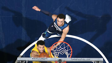 MINNEAPOLIS, MN - DECEMBER 27: Jamal Murray #27 of the Denver Nuggets dunks against Tyus Jones #1 of the Minnesota Timberwolves on December 27, 2017 at Target Center in Minneapolis, Minnesota. NOTE TO USER: User expressly acknowledges and agrees that, by downloading and or using this Photograph, user is consenting to the terms and conditions of the Getty Images License Agreement. Mandatory Copyright Notice: Copyright 2017 NBAE (Photo by David Sherman/NBAE via Getty Images)