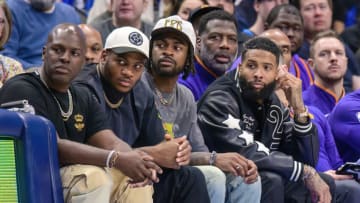 Dec 5, 2022; Dallas, Texas, USA; (from left) Talent manager Corey Gamble and Dallas Cowboys linebacker Micah Parsons and Cowboys cornerback Trevon Diggs and wide receiver free agent Odell Beckham Jr. (black jacket) watch the game between the Dallas Mavericks and the Phoenix Suns at the American Airlines Center. Mandatory Credit: Jerome Miron-USA TODAY Sports
