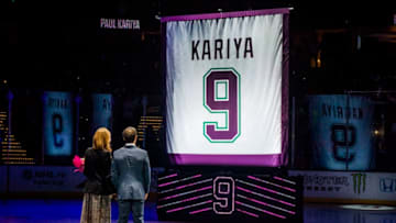ANAHEIM, CA - OCTOBER 21: Former Anaheim Duck Paul Kariya and his partner Valerie Dawson watch as the banner gets raised during his jersey retirement ceremony prior to the game against the Buffalo Sabres on October 21, 2018 at Honda Center in Anaheim, California. (Photo by Debora Robinson/NHLI via Getty Images)