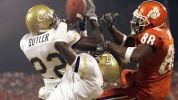 CLEMSON, SC - SEPTEMBER 11: James Butler #22 (L) and Kenny Scott #2 of the Georgia Tech Yellow Jackets breaks up a last-second pass to Kelvin Grant #88 of the Clemson University Tigers to hold on for a 28-24 win during an Atlantic Coast Conference game on September 11, 2004 at Clemson Memorial Stadium in Clemson, South Carolina. (Photo By Grant Halverson/Getty Images)