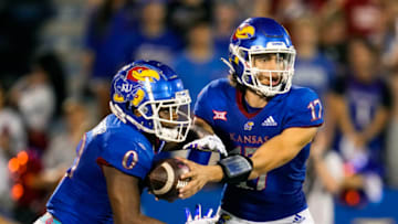 Sep 3, 2021; Lawrence, Kansas, USA; Kansas Jayhawks quarterback Jason Bean (17) hands off to running back Velton Gardner (0) against the South Dakota Coyotes during the first half at David Booth Kansas Memorial Stadium. Mandatory Credit: Jay Biggerstaff-USA TODAY Sports