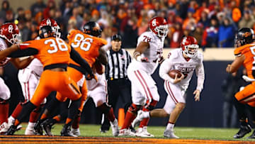 Nov 28, 2015; Stillwater, OK, USA; Oklahoma Sooners quarterback Baker Mayfield (6) runs the ball as tackle Orlando Brown (78) blocks against the Oklahoma State Cowboys at Boone Pickens Stadium. The Sooners defeated the Cowboys 58-23. Mandatory Credit: Mark J. Rebilas-USA TODAY Sports