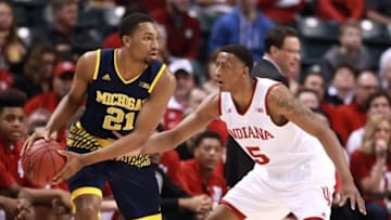 Mar 11, 2016; Indianapolis, IN, USA; Michigan Wolverines guard Zak Irvin (21) is guarded by Indiana Hoosiers forward Troy Williams (5) during the Big Ten Conference tournament at Bankers Life Fieldhouse. Michigan wins 72-69. Mandatory Credit: Brian Spurlock-USA TODAY Sports