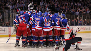 NEW YORK, NY - MAY 07: Marc Staal #18 of the New York Rangers celebrates with his teammates after scoring the winning goal in overtime against Braden Holtby #70 of the Washington Capitals as Matt Hendricks #26 of the Washington Capitals slides to the ice after Game Five of the Eastern Conference Semifinals during the 2012 NHL Stanley Cup Playoffs at Madison Square Garden on May 7, 2012 in New York City. The New York Rangers defeated the Washington Capitals in overtime 2-3. (Photo by Bruce Bennett/Getty Images)