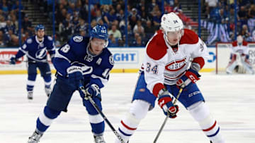 Mar 31, 2016; Tampa, FL, USA; Montreal Canadiens right wing Michael McCarron (34) skates with the puck as Tampa Bay Lightning left wing Ondrej Palat (18) defends during the first period at Amalie Arena. Mandatory Credit: Kim Klement-USA TODAY Sports