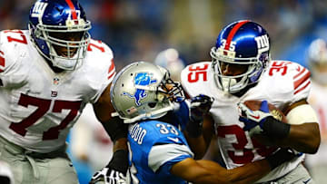 Dec 22, 2013; Detroit, MI, USA; New York Giants running back Andre Brown (35) is tackled by Detroit Lions cornerback Chris Greenwood (33) during the third quarter at Ford Field. Mandatory Credit: Andrew Weber-USA TODAY Sports