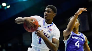 Feb 2, 2021; Lawrence, Kansas, USA; Kansas Jayhawks guard Tyon Grant-Foster (1) grabs a rebound against Kansas State Wildcats forward Seryee Lewis (4) during the second half at Allen Fieldhouse. Mandatory Credit: Jay Biggerstaff-USA TODAY Sports