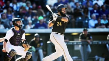 Sep 24, 2015; Denver, CO, USA; Pittsburgh Pirates first baseman Pedro Alvarez (24) hits a home run during the eighth inning against the Colorado Rockies at Coors Field. The Pirates won 5-4. Mandatory Credit: Chris Humphreys-USA TODAY Sports
