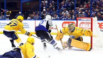 Dec 8, 2022; Tampa, Florida, USA; Tampa Bay Lightning center Vladislav Namestnikov (90) shoots as Nashville Predators defenseman Dante Fabbro (57), defenseman Jeremy Lauzon (3) and goaltender Juuse Saros (74) defend during the third period at Amalie Arena. Mandatory Credit: Kim Klement-USA TODAY Sports