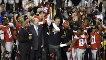 Jan 12, 2015; Arlington, TX, USA; Ohio State Buckeyes head coach Urban Meyer holds up the trophy after the win over the Oregon Ducks in the 2015 CFP National Championship Game at AT&T Stadium. Ohio State won 42-20. Mandatory Credit: Jerome Miron-USA TODAY Sports
