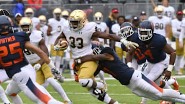 Oct 1, 2016; East Rutherford, NJ, USA; Notre Dame Fighting Irish running back Josh Adams (33) is tackled by Syracuse Orange cornerback Corey Winfield (11) in the first quarter at MetLife Stadium. Mandatory Credit: Matt Cashore-USA TODAY Sports