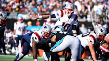 CHARLOTTE, NC - NOVEMBER 07: Mac Jones #10 of the New England Patriots calls a play at the line against the Carolina Panthers at Bank of America Stadium on November 7, 2021 in Charlotte, North Carolina. (Photo by Lance King/Getty Images)