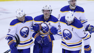Feb 20, 2021; Newark, New Jersey, USA; Buffalo Sabres defenseman Jake McCabe (19) reacts while being helped off the ice by teammates after suffering an apparent injury during the during the third period against the New Jersey Devils at Prudential Center. Mandatory Credit: Vincent Carchietta-USA TODAY Sports