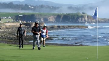 Feb 15, 2015; Pebble Beach, CA, USA; Jon Curran and Pat Perez walk up to the eighteenth green during the final round of the Pebble Beach Pro-Am at Pebble Beach Golf Links. Mandatory Credit: Jason Getz-USA TODAY Sports