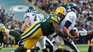Nov 10, 2013; Green Bay, WI, USA; Green Bay Packers defensive end Mike Daniels (76) sacks Philadelphia Eagles quarterback Nick Foles (9) in the fourth quarter at Lambeau Field. The Eagles won 27-13. Mandatory Credit: Benny Sieu-USA TODAY Sports