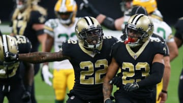 NEW ORLEANS, LOUISIANA - SEPTEMBER 27: Marshon Lattimore #23 of the New Orleans Saints celebrates with Chauncey Gardner-Johnson #22 after stopping Aaron Jones of the Green Bay Packers on fourth down during the second half at Mercedes-Benz Superdome on September 27, 2020 in New Orleans, Louisiana. (Photo by Sean Gardner/Getty Images)
