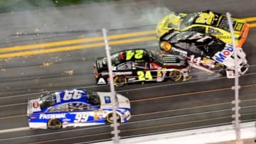 Feb 15, 2014; Daytona Beach, FL, USA; NASCAR Sprint Cup Series driver Matt Kenseth (20), Tony Stewart (14), Jeff Gordon (24) and Carl Edwards (99) are involved in a multi car crash on the front stretch during the Sprint Unlimited at Daytona International Speedway. Mandatory Credit: Andrew Weber-USA TODAY Sports