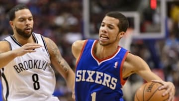Apr 5, 2014; Philadelphia, PA, USA; Philadelphia 76ers guard Michael Carter-Williams (1) is defended by Brooklyn Nets guard Deron Williams (8) during the first quarter at the Wells Fargo Center. Mandatory Credit: Howard Smith-USA TODAY Sports