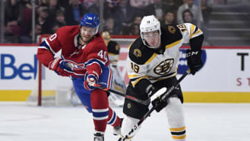 Nov 5, 2019; Montreal, Quebec, CAN; Boston Bruins forward Zach Senyshyn (19) plays the puck and Montreal Canadiens forward Joel Armia (40) defends during the second period at the Bell Centre. Mandatory Credit: Eric Bolte-USA TODAY Sports