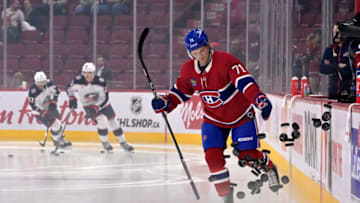 Oct 26, 2023; Montreal, Quebec, CAN; Montreal Canadiens forward Jake Evans (71) drops the pucks during the warmup period before the game against the Columbus Blue Jackets at the Bell Centre. Mandatory Credit: Eric Bolte-USA TODAY Sports