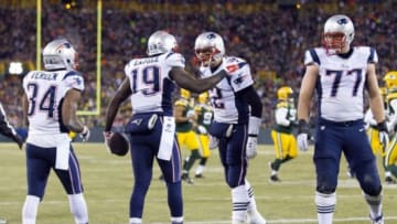 Nov 30, 2014; Green Bay, WI, USA; New England Patriots quarterback Tom Brady (12) and wide receiver Brandon LaFell (19) celebrate following a touchdown during the second quarter against the Green Bay Packers at Lambeau Field. Mandatory Credit: Jeff Hanisch-USA TODAY Sports