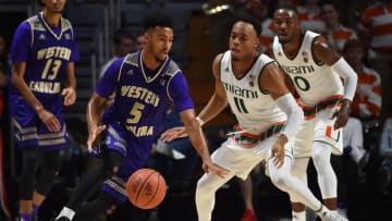 Nov 11, 2016; Coral Gables, FL, USA; Western Carolina Catamounts guard Devin Peterson (5) dribbles the ball around Miami Hurricanes guard Bruce Brown (11) during the first half at Watsco Center. Mandatory Credit: Jasen Vinlove-USA TODAY Sports