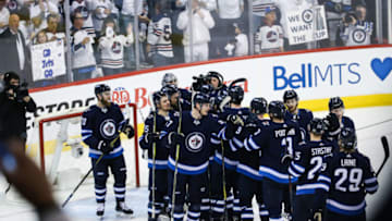 WINNIPEG, MB April 20: Winnipeg Jets players celebrate their victory during the Stanley Cup Playoffs First Round Game 5 between the Winnipeg Jets and the Minnesota Wild on April 20, 2018 at the Bell MTS Place in Winnipeg MB. (Photo by Terrence Lee/Icon Sportswire via Getty Images)