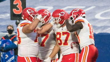 Oct 19, 2020; Orchard Park, New York, USA; Kansas City Chiefs tight end Travis Kelce (87) is congratulated by offensive guard Nick Allegretti (73) and wide receiver Tyreek Hill (10) after scoring a touchdown against the Buffalo Bills in the second quarter at Bills Stadium. Mandatory Credit: Mark Konezny-USA TODAY Sports