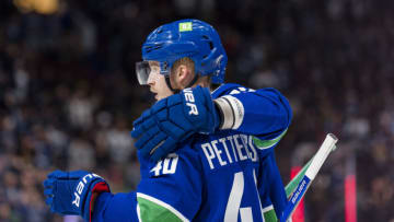 Apr 18, 2022; Vancouver, British Columbia, CAN; Vancouver Canucks forward Elias Pettersson (40) and defenseman Oliver Ekman-Larsson (23) celebrate PetterssonÕÕs empty net goal against the Dallas Stars in the third period at Rogers Arena. Canucks won 6-2. Mandatory Credit: Bob Frid-USA TODAY Sports