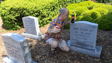 Paul Keisler takes a photograph of himself with two new top-10 graveyard stones outside the practice facility at Clemson University Tuesday. Keisler said he looks forward to the new season, and waits for decision that may be implemented this new season in regard to Coronavirus. Clemson has 34 markers in the graveyard, one for each win over top-10 teams, including the ACC championship win over Virginia and number two Ohio State at Arizona in the Fiesta Bowl last December 28, 2019.Clemson Football Fans Wait For Football