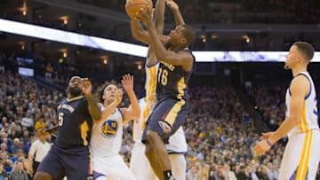 Mar 14, 2016; Oakland, CA, USA; New Orleans Pelicans guard Toney Douglas (16) shoots the ball as Golden State Warriors forward Draymond Green (23) defends in the second quarter at Oracle Arena. Mandatory Credit: Neville E. Guard-USA TODAY Sports