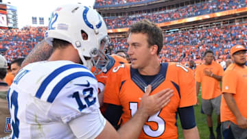 Sep 18, 2016; Denver, CO, USA; Indianapolis Colts quarterback Andrew Luck (12) greets Denver Broncos quarterback Trevor Siemian (13) following the game at Sports Authority Field at Mile High. The Broncos defeated the Colts 34-20. Mandatory Credit: Ron Chenoy-USA TODAY Sports